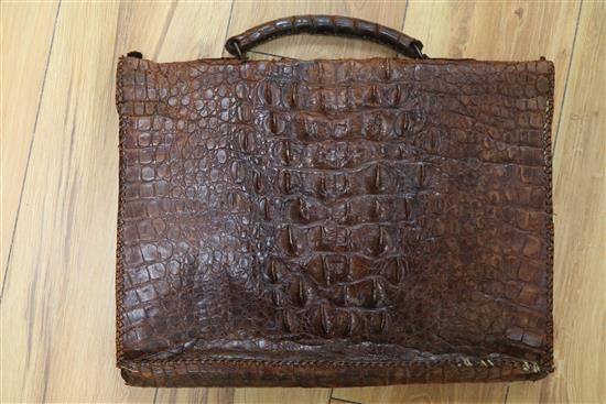 An early 20th century crocodile skin briefcase and a suitcase length 49cm